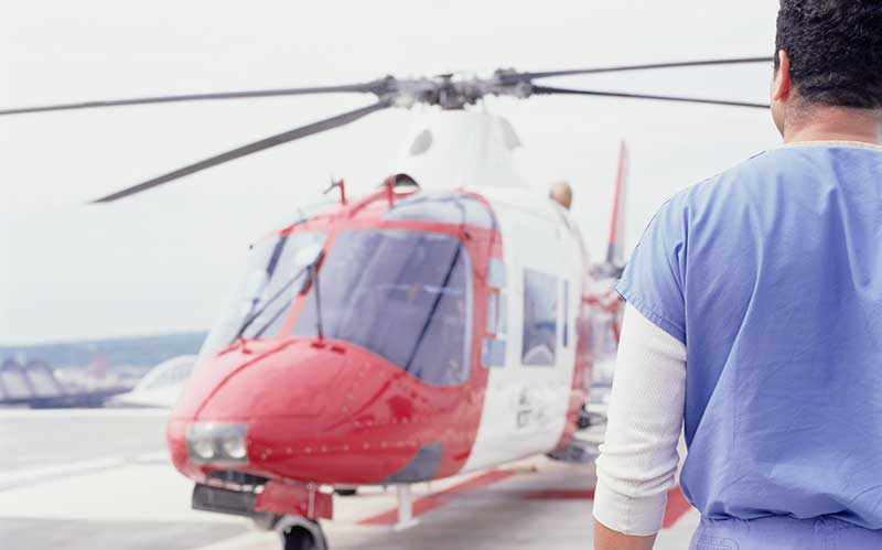 A medic walking towards an air ambulance